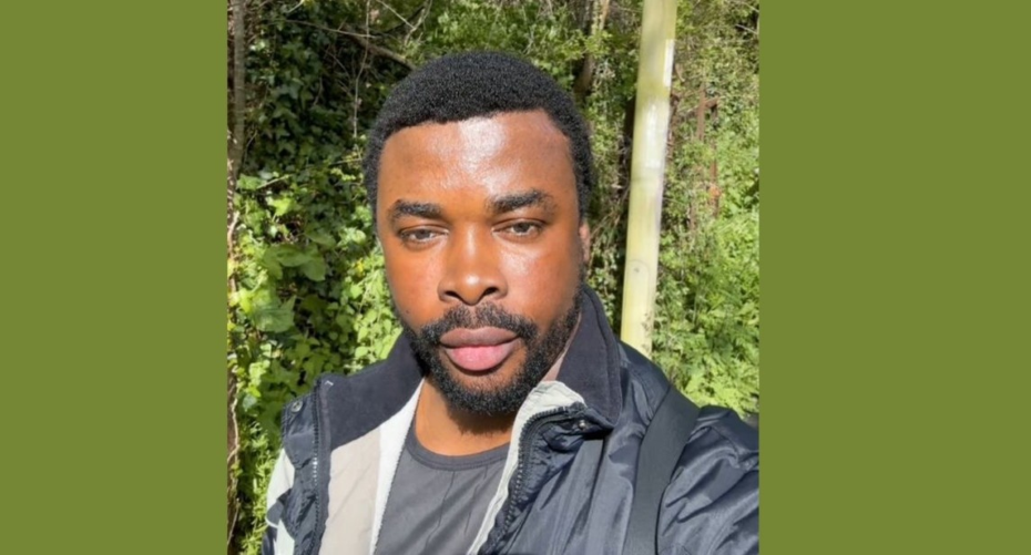 Aniefiok standing in front of green trees