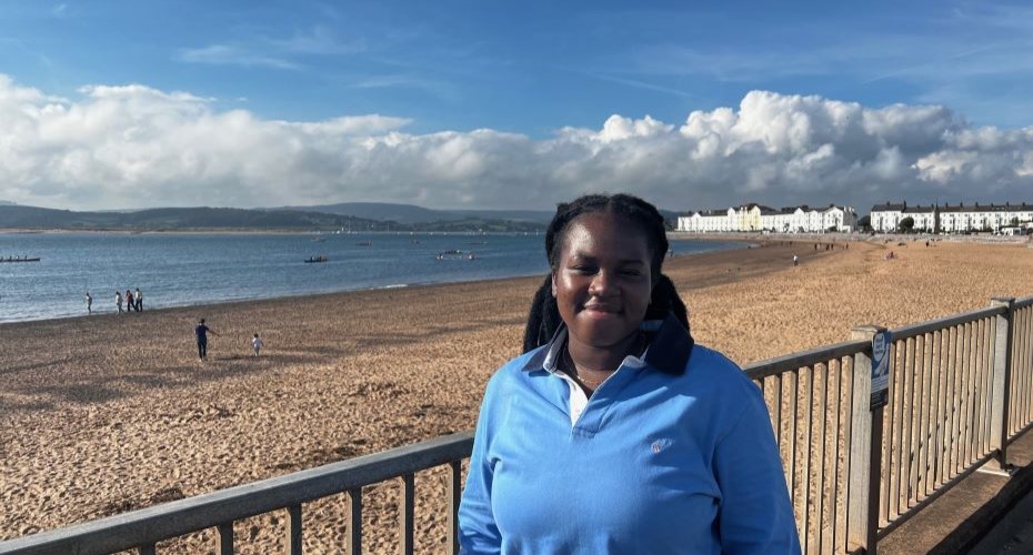 Student next to a beach in the sunshine