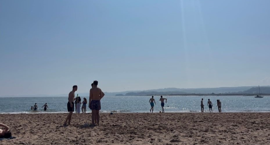 Students on Exmouth beach on a sunny day