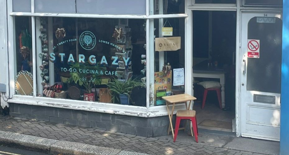 Front of Stargazy Cafe, which has a white-framed big window and open door