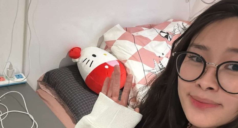Student smiling at the camera in their student accommodation bedroom