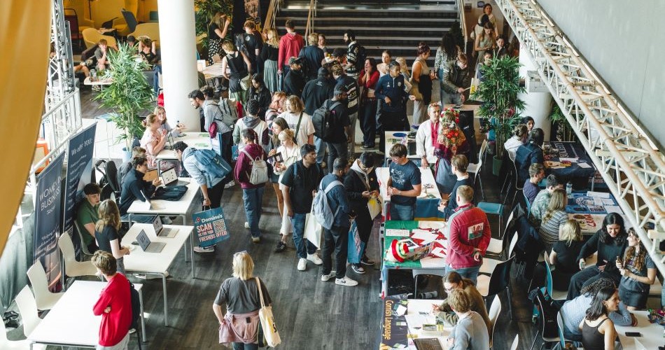A room full of students and society stalls