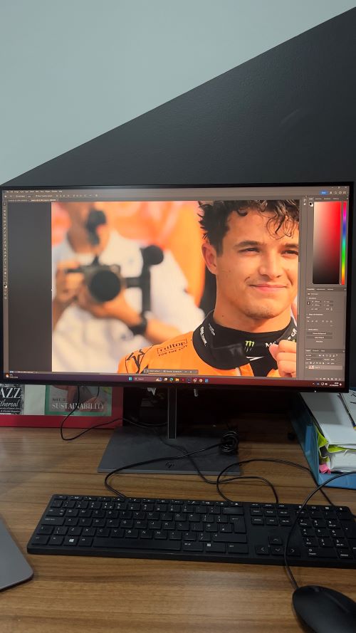 Computer monitor showing an image of an F1 driver