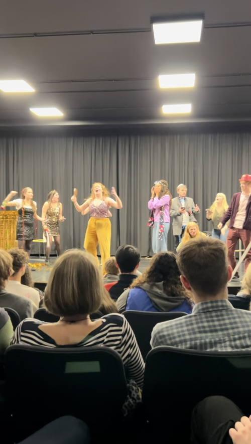 Student performance on a stage taken from a seat in the audience