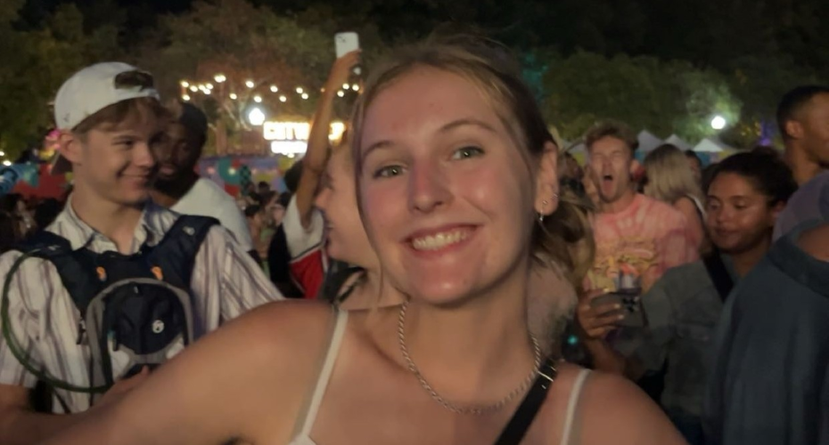 photo of Chloe at an outdoor event with lights and people behind her