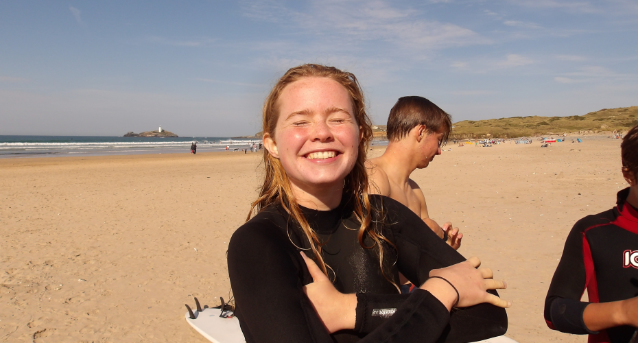 photo of Ruby with a sandy beach and ocean behind her