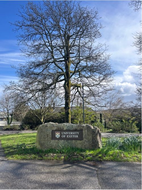 Sign for the University of Exeter Cornwall campus with a tree in the background