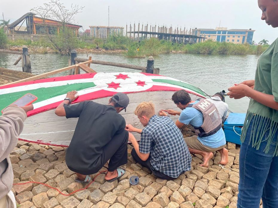 Josh and local students and fishermen working on the boat